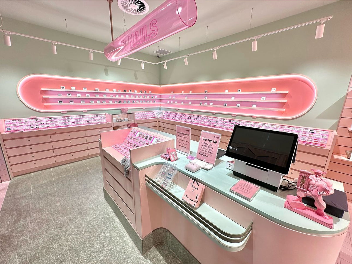 Inside the BNAILS Melbourne Central store, with pink nail displays and mint counters