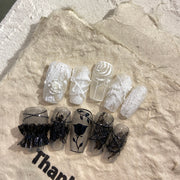Gorgeous nails with black and white plaster roses