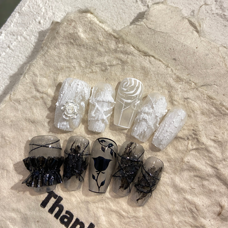 Gorgeous nails with black and white plaster roses
