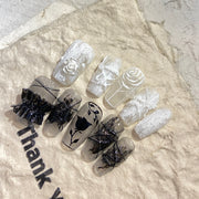 Gorgeous nails with black and white plaster roses